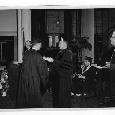 Tropaia exercises during 1955 graduation/commencement with Edward G. Jacklin, S.J., Matthew Sullivan, S.J., and others.