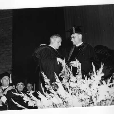 Edward G. Jacklin,S.J., bestowing honorary degree on John J. Hearne with John McShain and Joseph S. Hogan, S.J. looking on during 1953 graduation/commencement ceremony.