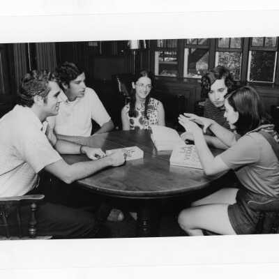 Joseph Daoust, S.J., Michael Plunkett, Paul Waerner, and others sitting around table discussing "La Vida."