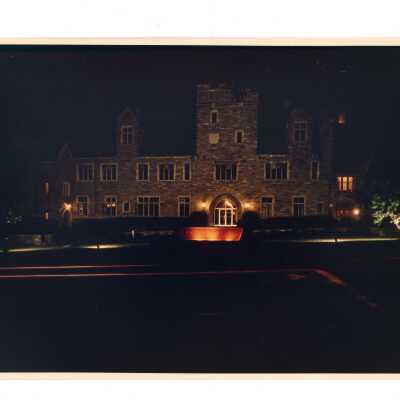 Exterior view of front of Barbelin building from City Avenue at night.