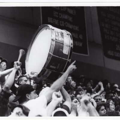 Students cheering with the Drum at Men's Basketball game