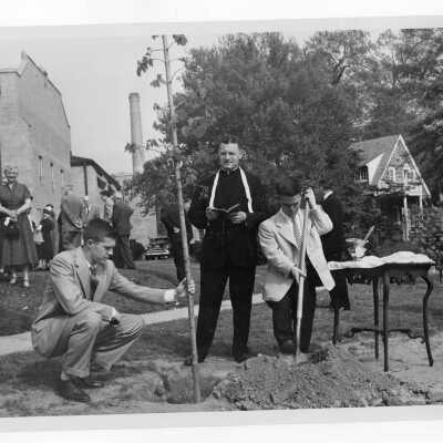 Students planting tree near Field House during Junior Week activities with Edward G. Jacklin, S.J. President, c. 1952.