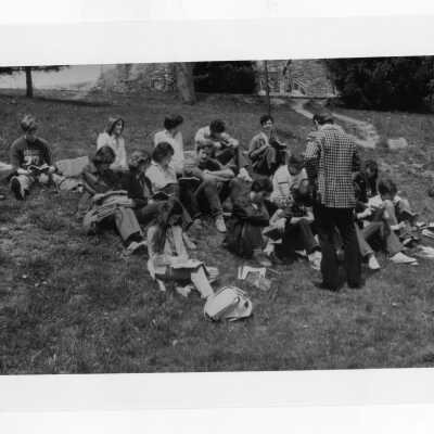 Students listening to lecture on hillside near Barbelin building?