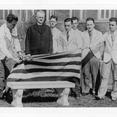 Students unveiling marble bench as part of Junior Week activities with William T. Tallon, S.J., President.