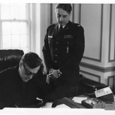Air Force ROTC Commander and Donald I. MacLean, S.J. signing agreement.