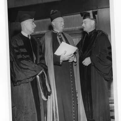 Edward G. Jacklin, S.J., with two honorary degree recipients, Joseph C. Cox, Sr. and Monsignor John J. Daly, during 1955 graduation/commencement.