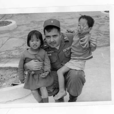 U.S. soldier with two Vietnamese children, part of Vietnam Orphanage Project.