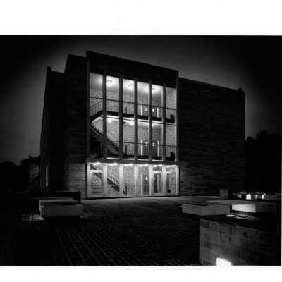 View of side entrance and interior stairwell of Villiger (later Post) Academy of Food Marketing at night.