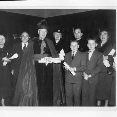 Honorary degree recipient, Bishop Thomas Feeney, S.J., with relatives after academic convocation, October 28, 1951, as part of centennial celebration.