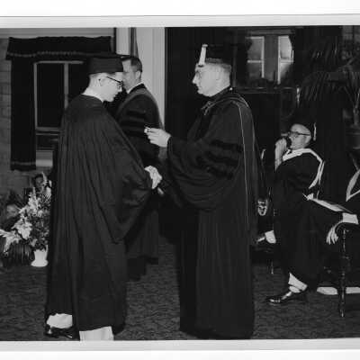 Tropaia exercises during 1955 graduation/commencement with Edward G. Jacklin, S.J., student, and others.