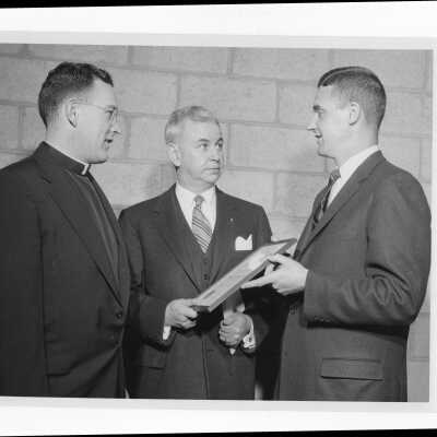 Dr. Francis Braceland showing Shaffrey award certificate to Father Leary and Dr. MacMurtrie, April 8, 1956.