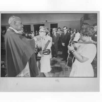 Pax Romana's 20th World Plenary Assembly meets at Saint Joseph's College, August 1968. Cardinal Krol is giving Holy Communion during Mass in Flanigan Auditorium.