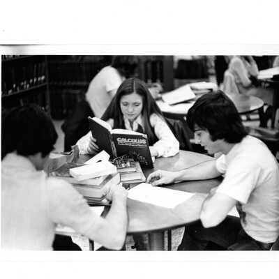 Students studying at table in Drexel Library.