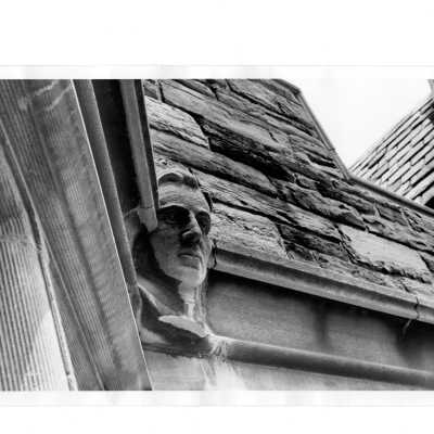 Gargoyle in likeness of one of SJC presidents on exterior of Barbelin building.