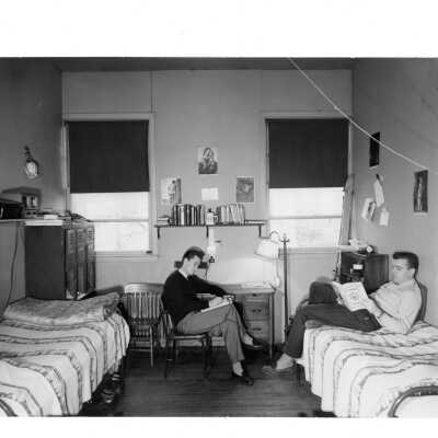 View of two students studying in dorm room in veterans barracks. Barracks located near Cardboard College also known as Barbelin Annex.