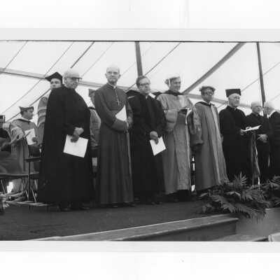 Rev. Pedro Arrupe, S.J., Dr. Thomas Melady, and others at academic convocation held on Gest Lawn, July 31, 1976, as part of SJC 125th anniversary celebration.