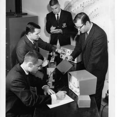Physics professor working with several students in microwave laboratory, May 1963.