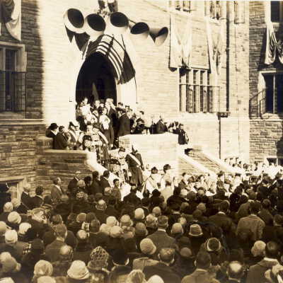 Crowds in Barbelin quadrangle during dedication of building. Photo shows loudspeakers and banners.