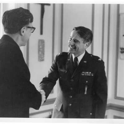 Donald I. MacLean, S.J. shaking hands with Air Force ROTC commander.