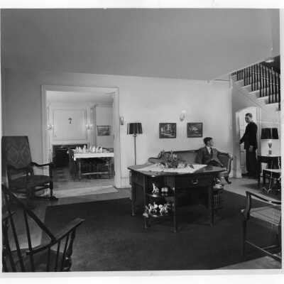 View of living and dining rooms of Greaton Hall with two students.