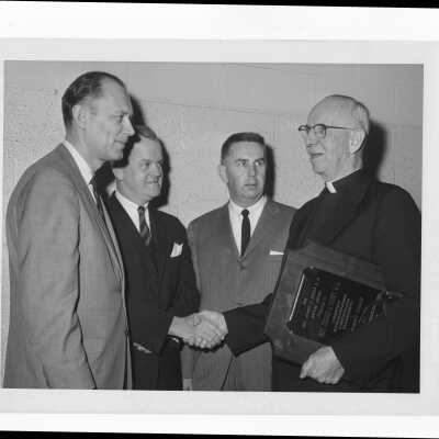 Dennis J. Comey, S.J., receiving Hogan Alumni Award, February 23, 1966.