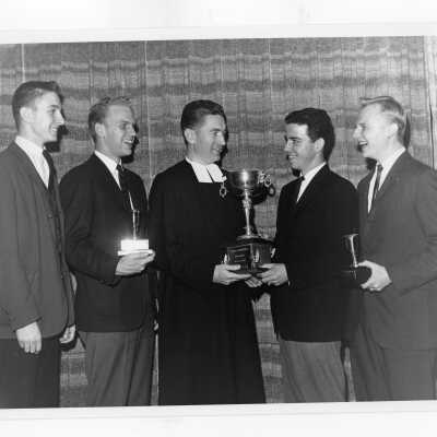 Students from Villiger Debating team, John Jenemann, Dennis Suplee, Louis Hoelzle, Davide Drueding, receiving trophy from Dr. Robert P. Newman.