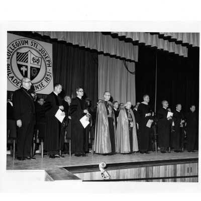 Dedication of Villiger (later Post) Academy of Food Marketing with William F. Maloney, S.J. and Augustin Cardinal Bea and others on stage of Bluett Auditorium.