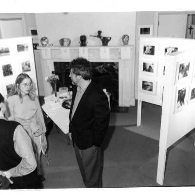 Dennis W. Weeks (Fine Arts) with two other individuals at exhibit in Boland Hall.