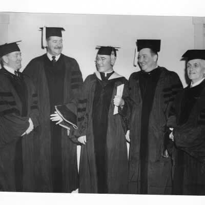 John J. Long, S.J., with Senator Francis J. Myers, Judge McGranery?, Thomas F. Murphy and Thomas K. Quirk at 1950 graduation/commencement ceremony.