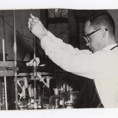Chemistry student working on experiment in science laboratory, c. 1965.