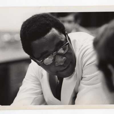 Biology professor, Kodwo J. Abaidoo, working with students in class, c. 1970.
