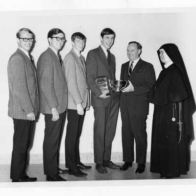 Students from Villiger Debating Society, Ronald Uzdavinis, Frederick Brodzinski, Eugene Comey, and Wayne Barrett, receiving award at Rosemont College Debate tournament.