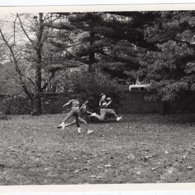 Men playing intramural football near Gest estate?