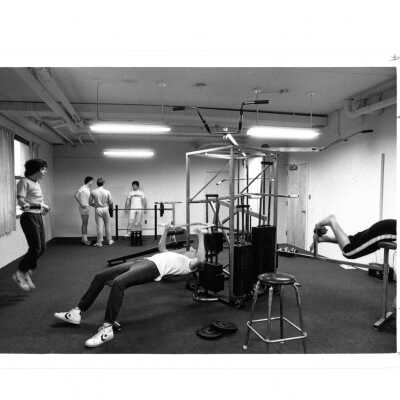 Students using equipment and weights in Sports Complex.