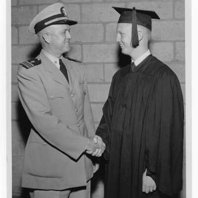 Tropaia exercises during 1955 graduation/commencement with military officer congratulating student after ceremony, possibly student Gordon Shockley with his father?