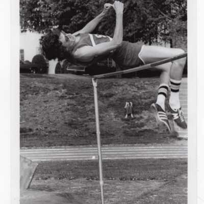 Men's track team member in high jump event.