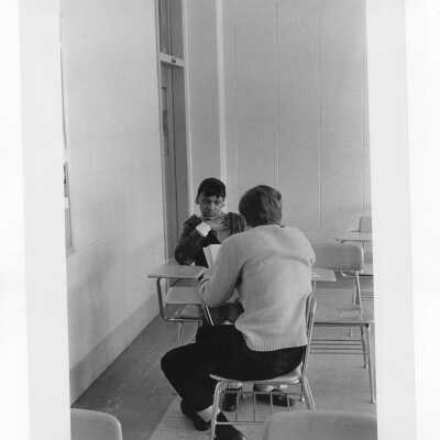 Student tutoring child at Rhoads Public School (?) as part of community service/outreach project. (Peace and Human Development program?)