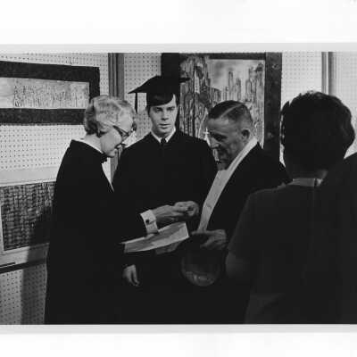 Inauguration of President Terrence Toland, S.J., November 14, 1968. Dr. Hilda Fell, assisted by James A. Borbely, Jr., President of the Student Body, directs guests to their stations before ceremony.