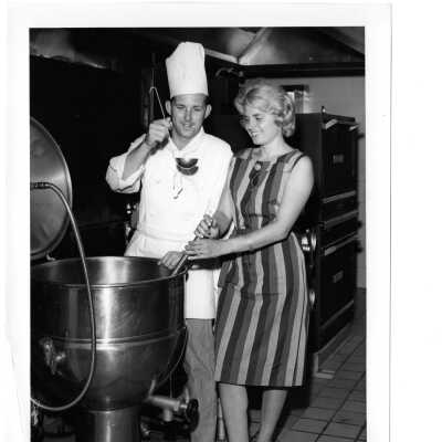 View of Campion kitchen with chef and woman cooking soup.