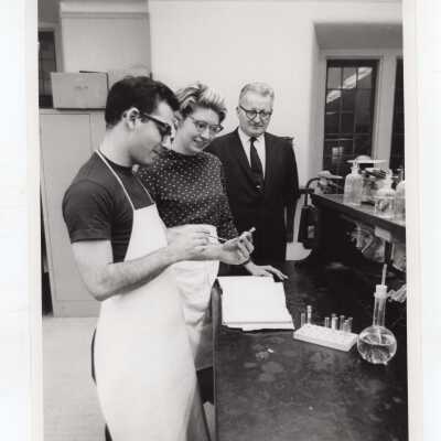 Chemistry professor, George Beichl, working with two students in science laboratory, c. 1968.