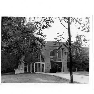 Exterior view of front of Campion with sign in yard advertising "Boat House Party."