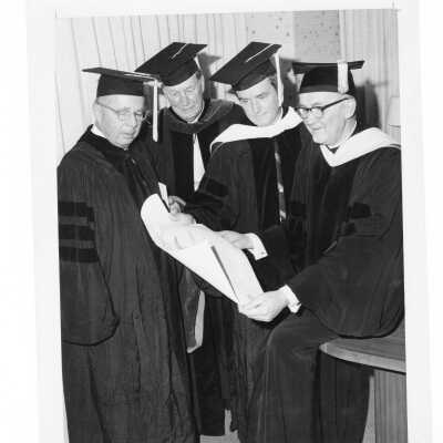 William F. Maloney, S.J., with three recipients of honorary degrees, Howard Butcher, III, Vincent P. McDevitt, and Mike Douglas during 1968 graduation/ceremony.