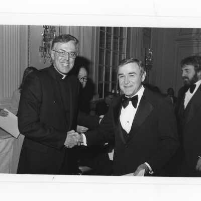 Donald I. MacLean, S.J., handing awards to William R. Deasey, Paul Foster, John P. Gallagher, Sr., and Charles V. Gantz during alumni awards dinner, c. 1980.