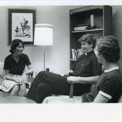Edward I. Denion, S.J.: Director of Campus Ministry; Director of Admissions. Fr. Denion and Anne Healy Ayella are meeting with a Student.
