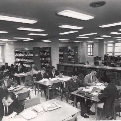 Interior view of reading room in Drexel Library with students studying at desks.