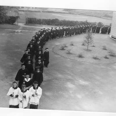 Students in cap and gown processing into Field House for either Baccalaureate or ceremony for 1951 graduation/commencement.