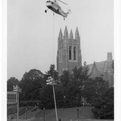 Helicopter lowering flood light on Finnesey Field.