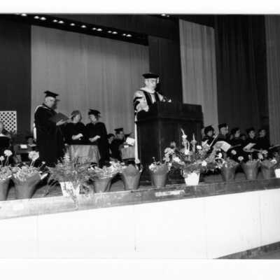Nicholas S. Rashford, S.J., addressing graduates and guests during 1990 graduation/commencement.