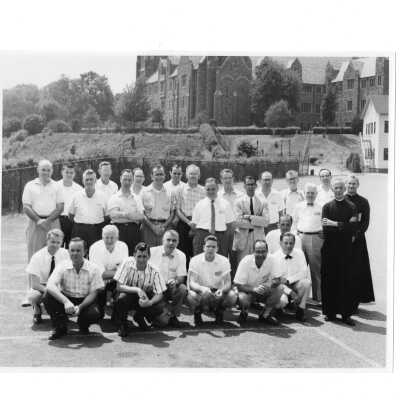 Summer alumni spiritual retreat on SJC campus, c. 1958, including Michael J. Smith, S.J. (Cardboard college buildings in background)