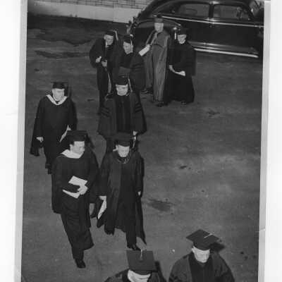 Procession of honorary degree recipients and others--Mr. Balderston, Fr. Gianea, Fr. Trundle, Joseph S. Hogan, S.J., Dulles, Bishop Feeney, T. Finletter, Edward G. Jacklin, S.J., to academic convocation during centennial celebration, October 28, 1951.